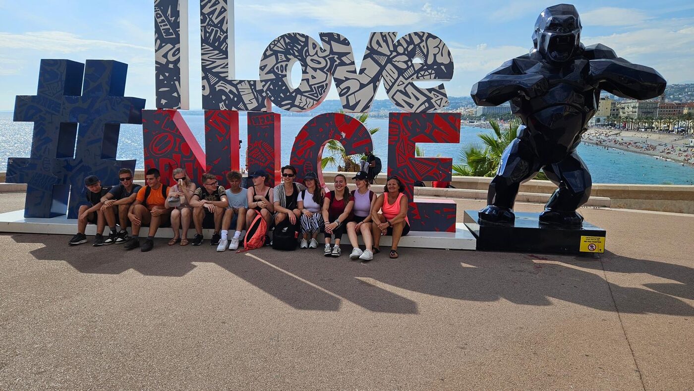 Un groupe d’élèves devant les lettres « I love Nice » sur la promenade